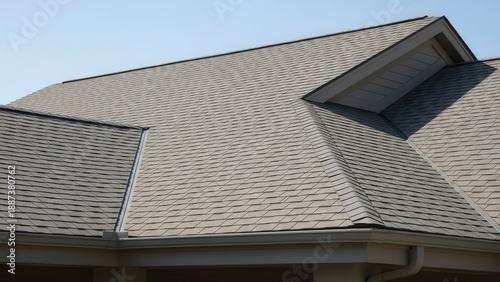 Gray Shingle Roof With Gutter System Under Blue Sky