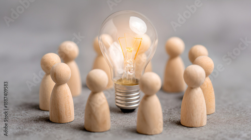 Large Glass Light Bulb Surrounded By A Circle Of Small Wooden Person Figures 