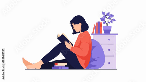 Person reading book while sitting on floor next to bedside table