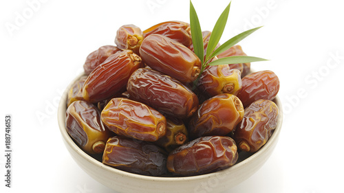 dates in a bowl with green leaf on top