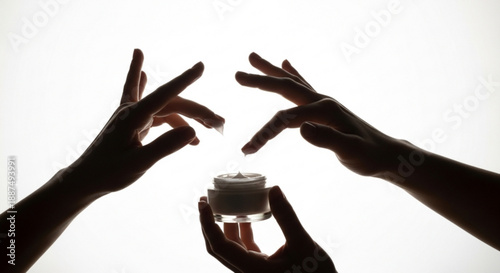 Delicate hands interact with a jar of white cosmetic cream, symbolizing mindful self-care, beauty rituals, and the application of nourishing products for healthy, radiant skin
