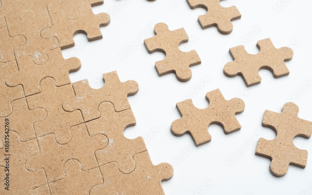 Fototapeta premium Wood Puzzle Pieces on white Background Representing Problem Solving
