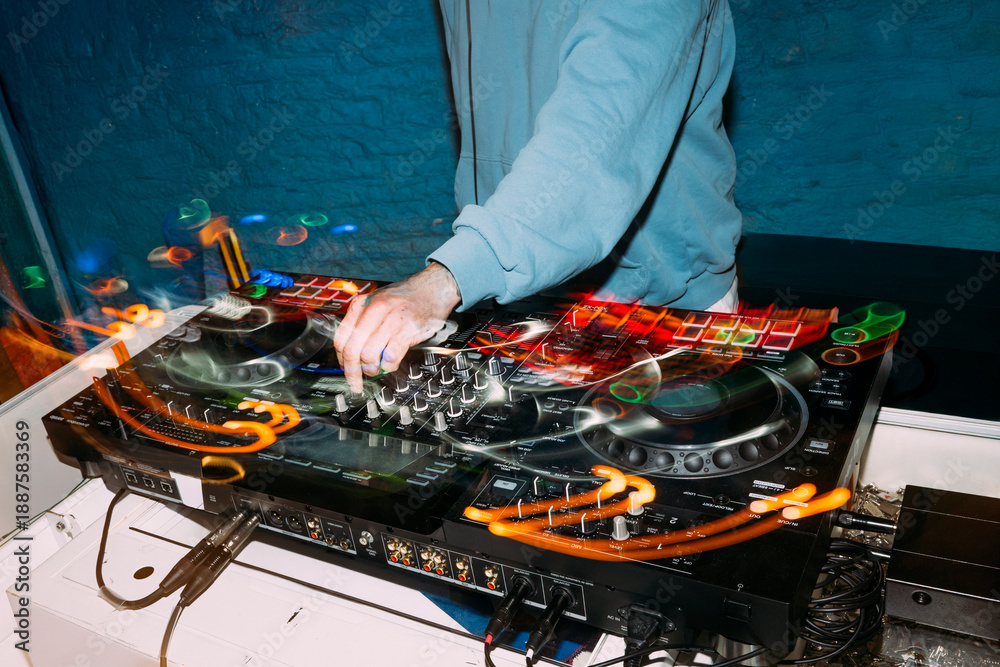 Naklejka premium Dj mixing music on controller at nightclub party