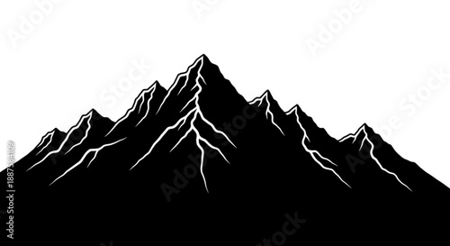 Silhouette of majestic mountains with snow-capped peaks against a clear sky viewed from a distance