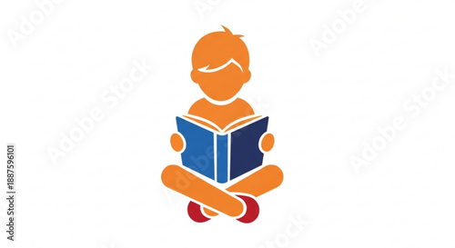 A young boy sitting cross legged reading a blue book with a calm expression on his face