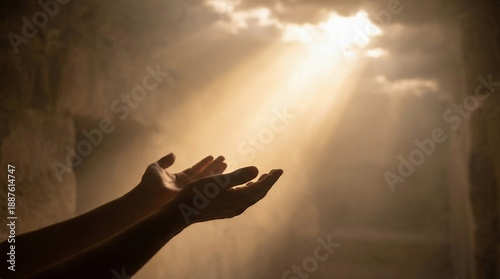 Open hands reaching towards a radiant light beam from above, symbolizing hope, spirituality, faith