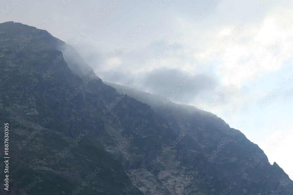 Fototapeta premium The North Caucasus Mountains in clouds and fog on a summer day