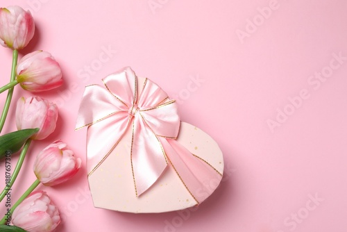 Beautiful postcard with fresh tulips and gift box card on pink background