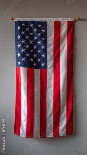 United States flag hanging on plain wall