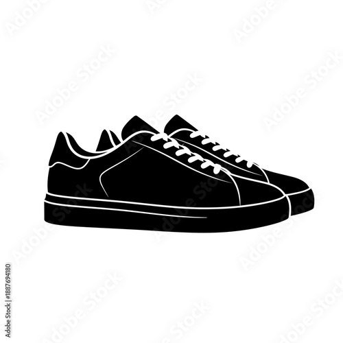 A pair of black sneakers with white laces on a plain background