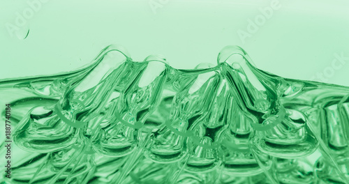 Glass medical ampoule vial for injection. Medicine is liquid sodium chloride with of aqueous solution in ampulla. Close up. Bottles ampule multicolor on background color and water. Human plasma.
