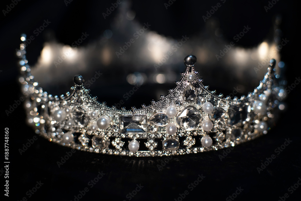 Obraz premium White golden crown with crystals, diamonds on black background.