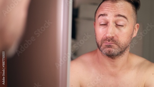 He displays calm assurance before meeting, An individual prepares confidently with attentive gaze and poised stance, Person exudes selfassurance and focus in preparation for upcoming interview
