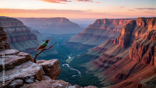 A vibrant hummingbird perches on a rocky outcrop, overlooking a vast, polychromatic canyon bathed in dawn light. A winding river traces the canyon floor, receding into the expansive vista.