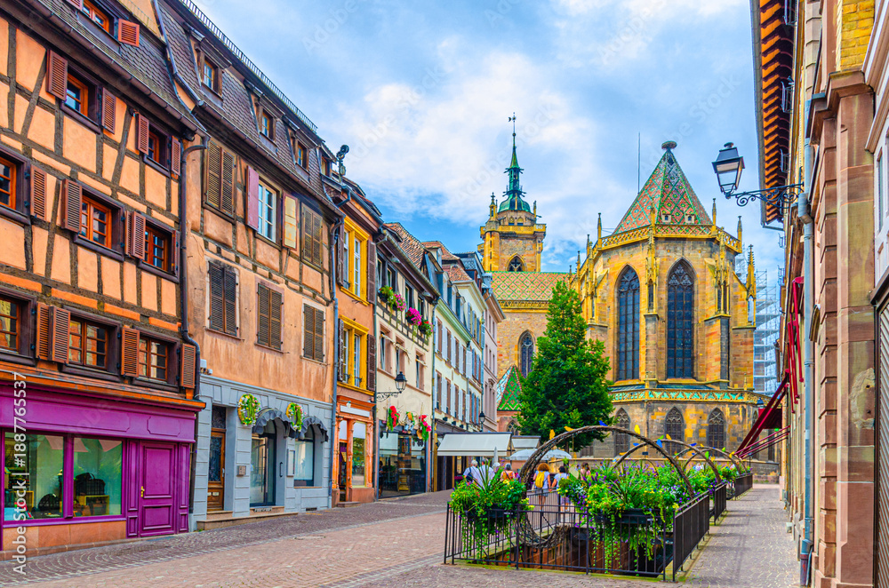 Obraz premium Old houses half-timbered style colorful facade, medieval buildings shutters windows on Rue de l'Église street, Saint-Martin church in old town Colmar city historic centre, Alsace region, France