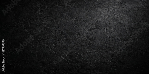 A dark grunge texture featuring a rough black and white pattern on an old weathered surface of gray fabric and metal canvas for a blank industrial wallpaper backdrop