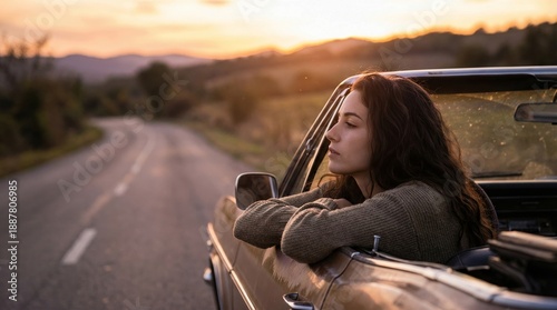 Young woman enjoying sunset drive in convertible car. Scenic road trip vibes create freedom and adventure. Ideal for lifestyle and travel concepts showcasing beauty of nature.