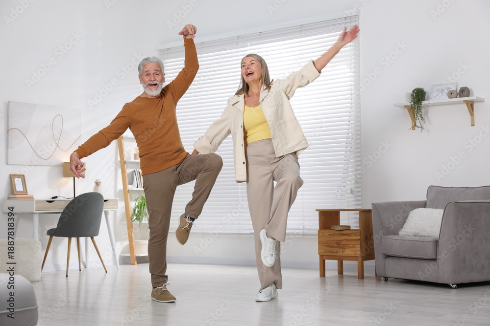 Fototapeta premium Happy senior couple dancing together at home