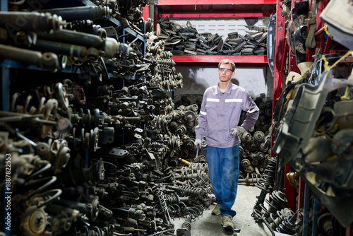 Photos Worker walks through a car parts junkyard in the factory