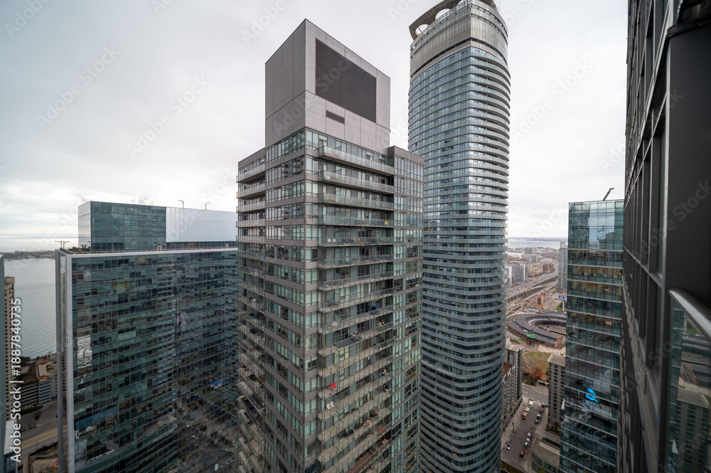Obraz premium Toronto financial district and waterfront featuring contemporary high rise skyscrapers, residential buildings, and a busy urban landscape under an overcast sky. In mimco