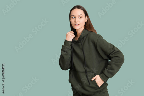 Young woman in hoodie on gr...