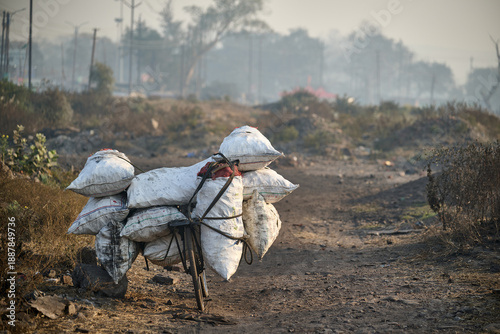 фотографія Bicycle loaded with heavy coal sacks in Dhanbad India