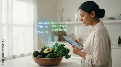 Woman in a modern kitchen using a digital tablet with augmented reality overlaying real time nutritional data and health information onto a bowl of fresh vegetables and fruits for diet management