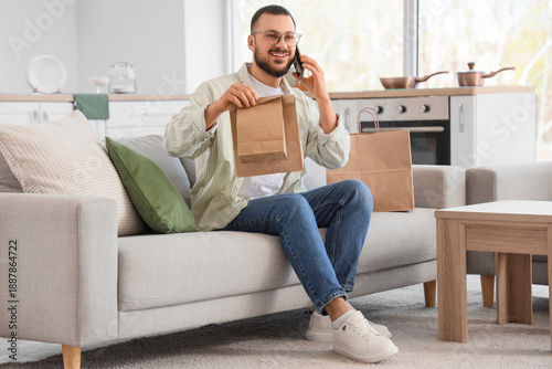 Young man with paper bags t...