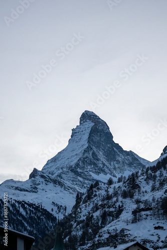 Matterhorn mountain peak rising above a snowy alpine landscape in winter, evoking skiing, mountaineering, adventure, and Swiss tourism.