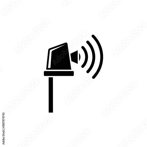 Black wireless speaker on pole outdoors.