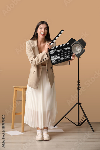 Young happy female film dir...