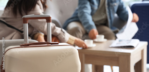 Suitcase against couple wit...