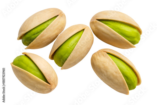 Collection of five open pistachio nuts with bright green kernels on a white background