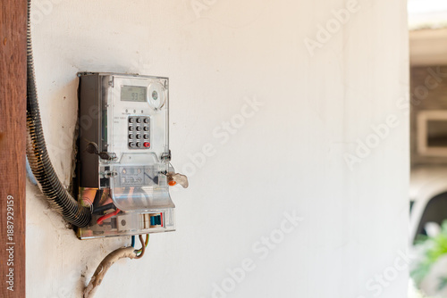 Electricity meter on the wall of the house to measure electricity consumption in the household