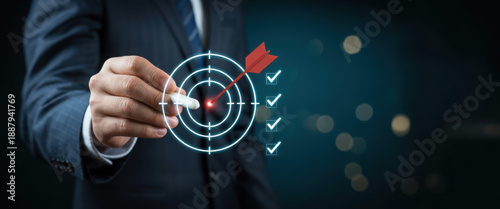 Business goal setting concept with businessman using digital stylus to target center of dartboard, symbolizing strategic planning, objective alignment, achievement checklist for organizational success