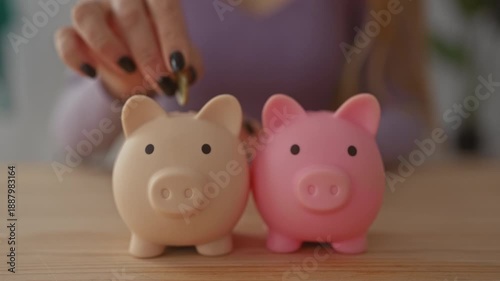 Woman saving money with two piggy banks on a wooden table in a cozy living room setting, highlighting ideas of financial planning and personal finance at home.