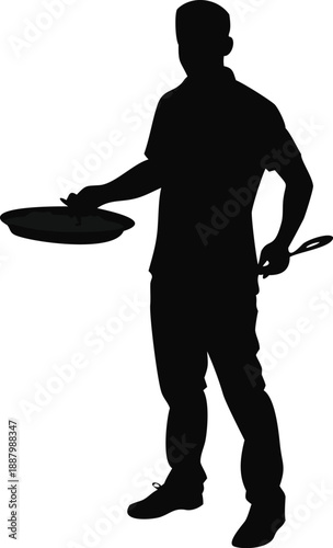 Silhouette Of A Man Holding A Paella Pan