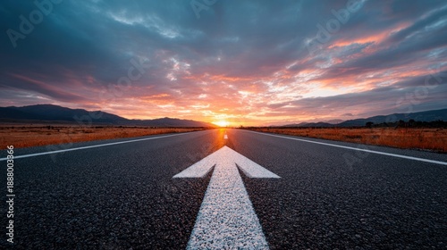Open road ahead with a sunrise and arrow marking the direction forward