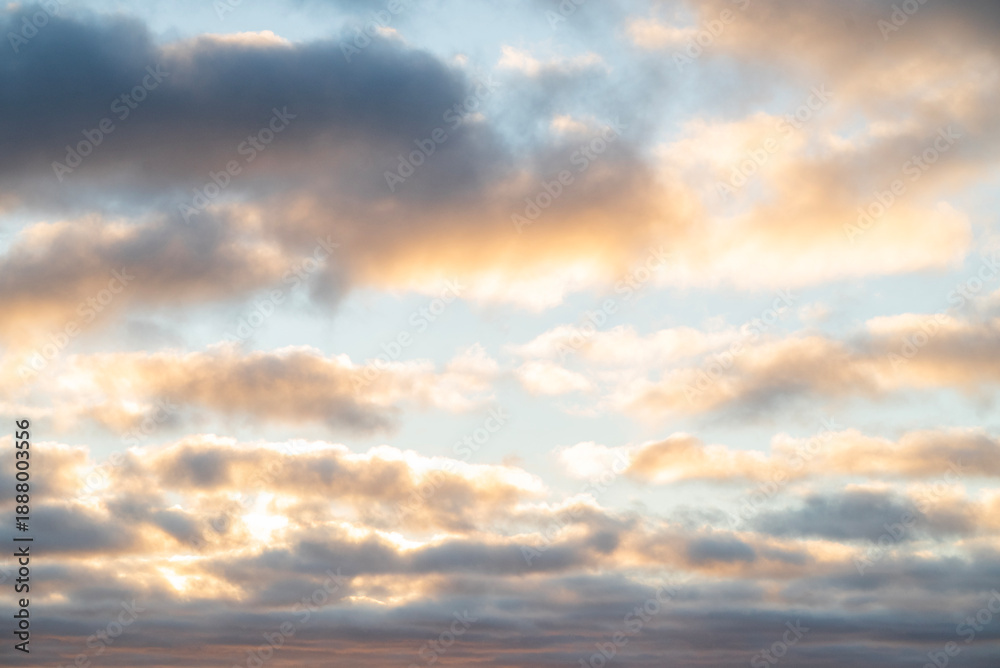 Fototapeta premium Beautiful clouds in the sky in pink and yellow shades at sunset or sunrise
