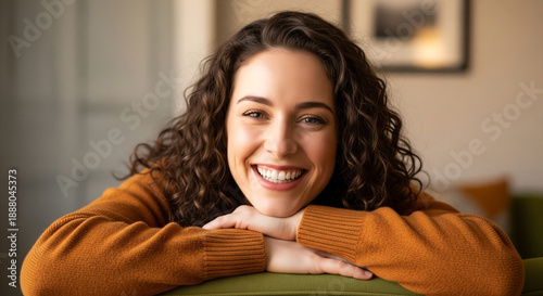 A young, fair-skinned woman, likely in her late 20s or early 30s, is the main subject. She is smiling broadly, with a genuine and joyful expression