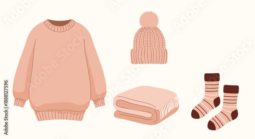 Set of cozy autumn essentials including a warm sweater, a beanie hat, a folded blanket, and a pair of striped socks in soft pink tones.