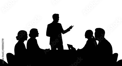 Business meeting silhouette of a speaker presenting to colleagues around a table