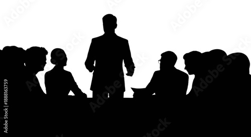 A professional male presenter addressing a diverse group of colleagues in a business meeting