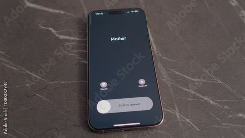 A smartphone vibrates strongly on a table, bounces up, and flies into the air when Mother calls. The screen shows her name and call options.