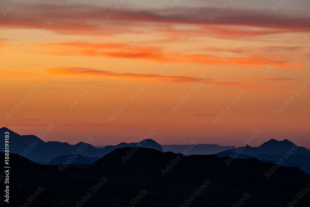 Fototapeta premium Orange Sky Blankets The Silhouetted Ridges Of Big Bend