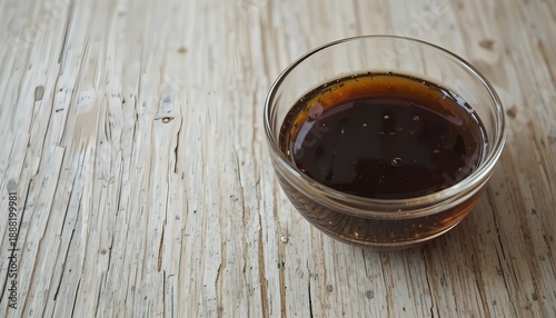 Glass bowl of khajoor placed on light wooden table, minimal style