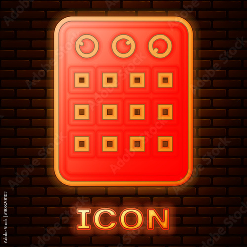 Glowing neon Drum machine icon isolated on brick wall background. Musical equipment. Vector