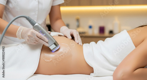 Young woman receiving cavitation for buttocks contouring in spa clinic for body shaping and cellulite reduction, beauty and figure correction, close-up