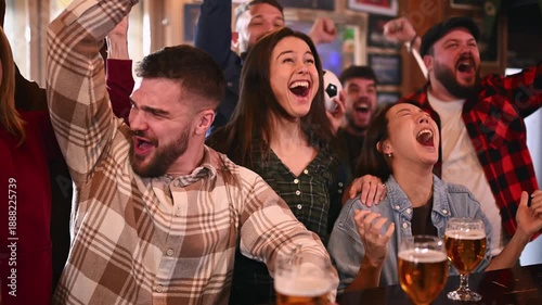 Excited friends celebrating a football match goal in a pub