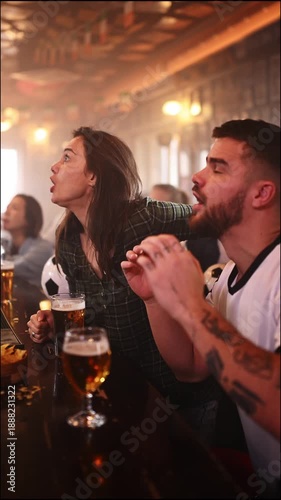 Excited football fans celebrating a goal in a sports bar